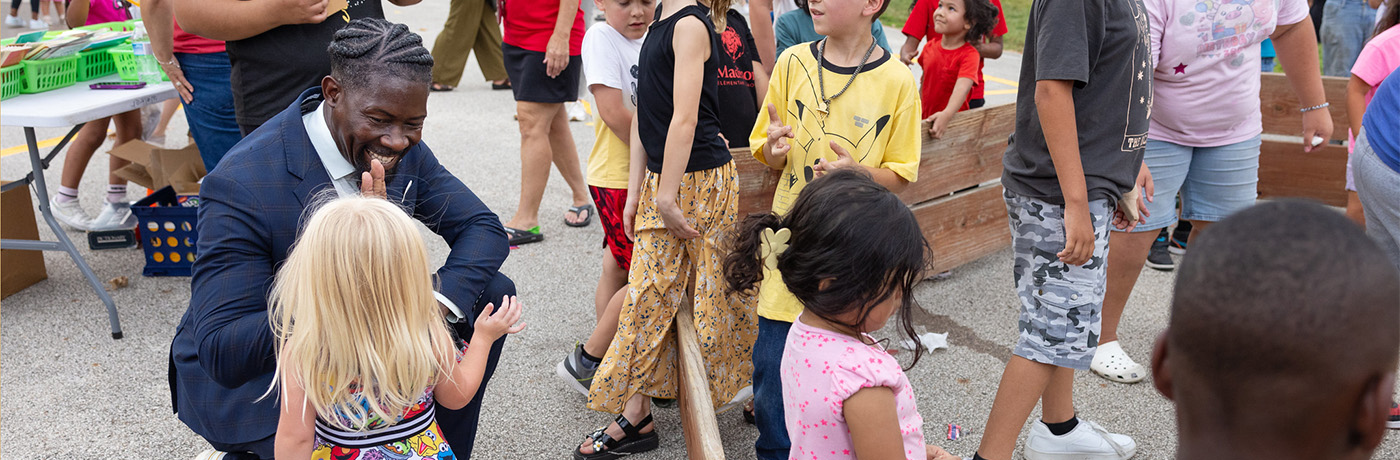 Superintendent high fiving student