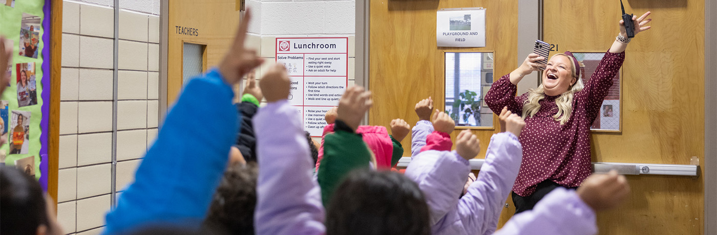 Students cheering with principal